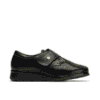 Botines de piel negros con cierre de velcro y textura en la parte superior, ideales para calzado cómodo y elegante.